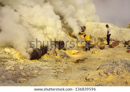 Ijen volcano crater, people working in sulfur mining industry
