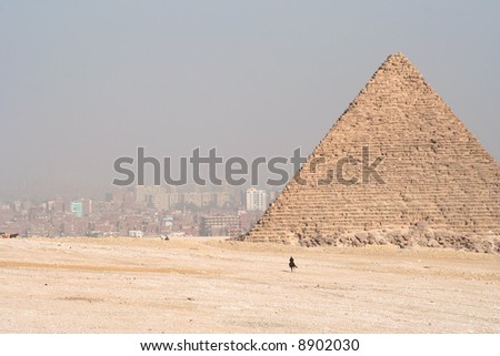 Pyramids in Egypt. Cairo in the background in smog.
