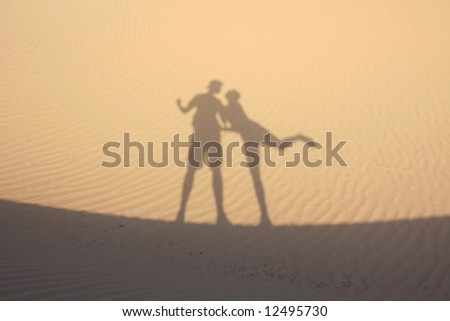 Shadow in dunes with playful figures