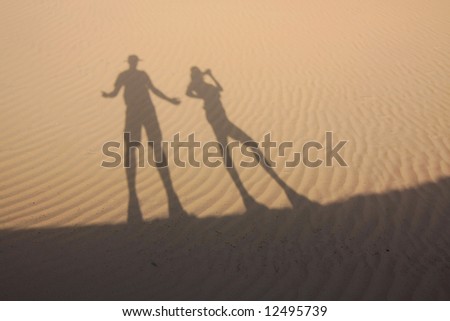 Shadow in dunes with playful figures