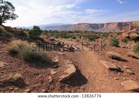Landscape with dry red rocks and bench, USA, Utah