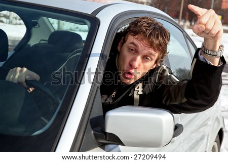 Aggressive driver concept, young man driving aggressively