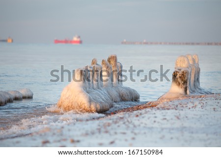 A peaceful scene with old pier piles in winter