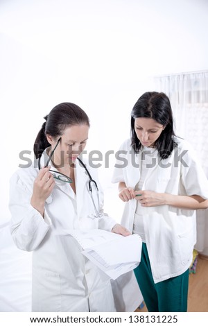 serious medical workers looking at documentation