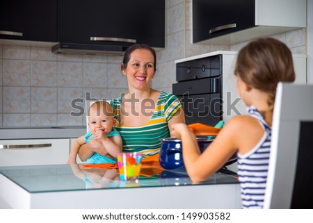 young mother having lunch with their children