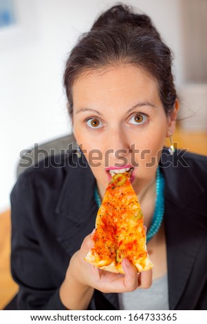woman eating a piece of pizza