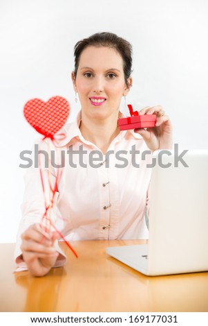 young businesswoman in office with valentines hearts and gift box