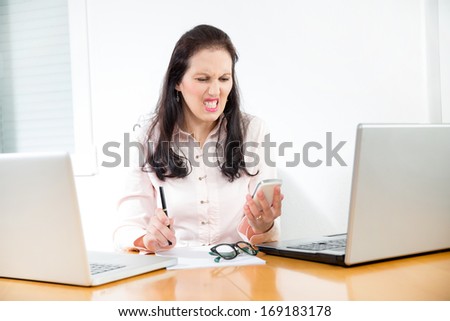 portrait of angry woman screaming at the phone