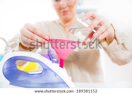 Woman fills iron  with water