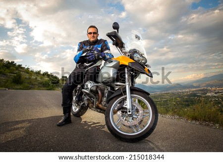 Biker man sitting on his motorcycle