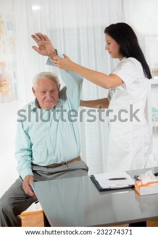 Chiropractic: Chiropractor examining senior man at office
