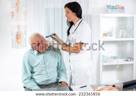 Doctor looking into patient's ear