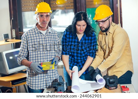 Construction worker and couple looking at the plan, selective focus