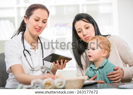Alternative Medicine - Homeopathy.Young woman and her child at the doctor homeopaths.  Treatment with herbs.
