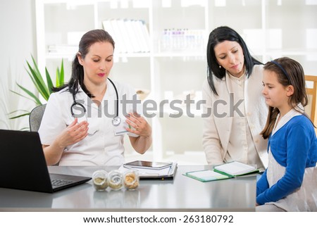 Alternative Medicine - Homeopathy.Young woman and her daughter at the doctor homeopaths.  Treatment with herbs.