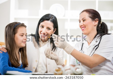 Alternative Medicine - Homeopathy.Young woman and her daughter at the doctor homeopaths.  Treatment with herbs