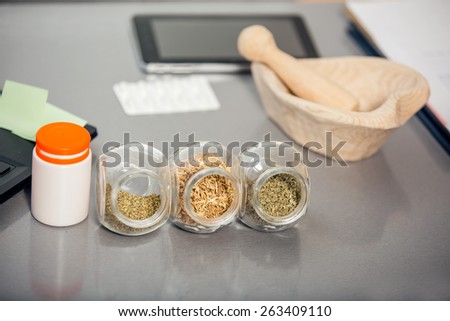 Herbal medicine - jars of herbs on the table. Homeopathy
