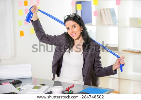 Business woman exercise in her office with stripe stretching