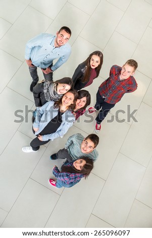 Group of students in the hall of the university, view from above. Selective focus