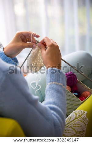 Female hands with knitting needles while knitting. Knitting therapy