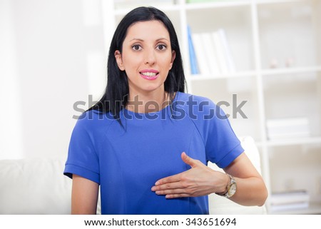 Beautiful smiling deaf woman using sign language