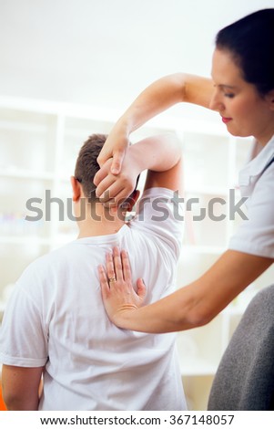 Chiropractor doing adjustment on male patient