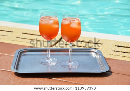 Pair of traditional Italian Spritz cocktails at the swimming pool