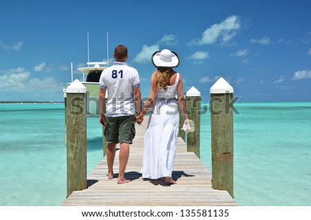 Couple on a wooden jetty. Exuma, Bahamas