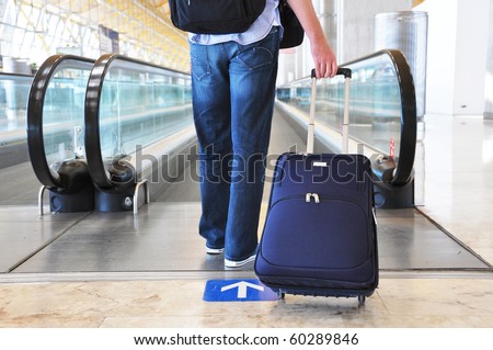 Traveler with a bag at the speedwalk