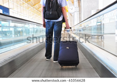 Traveler with a bag on the speedwalk