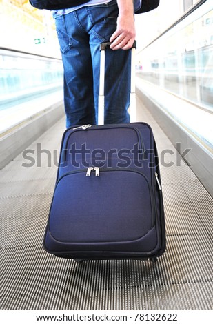 Traveler with a suitcase on the speed walk