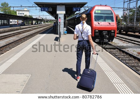 Girl with a suitcase at the train station