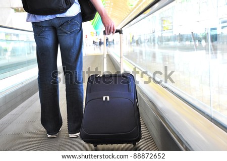 Traveler with a suitcase on the speedwalk