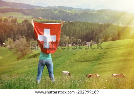 Girl holding Swiss flag. Emmental, Switzerland