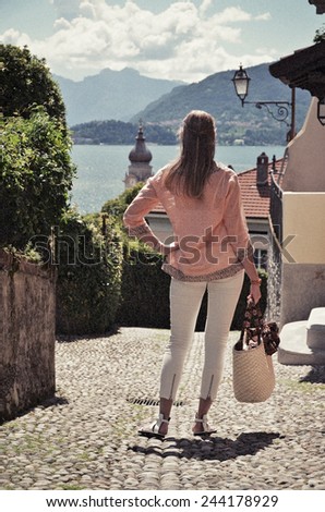 Girl on the cobbled street of Menaggio town. Lake Como, Italy -- retro nostalgic filtered look
