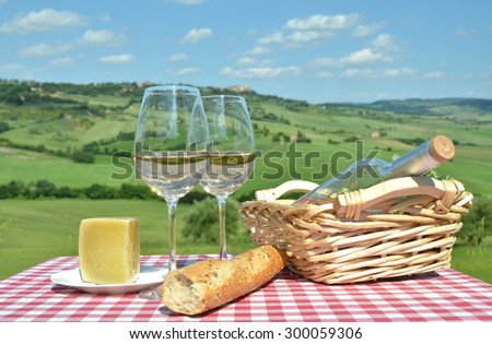 White wine on the table against Tuscan landsacpe, Italy