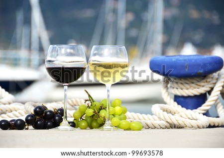 Wineglasses and grapes on the yacht pier of La Spezia, Italy
