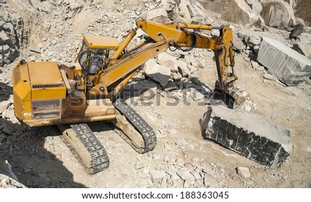 Granite quarry. Working mining machines. Mining industry.