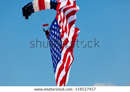 WASHINGTON DC - MAY 8:A skydiver Paul McCowan with US flag parachuting at the Joint Services Open House airshow on May 8,2012. It is the second largest known flyable American flag in existence.