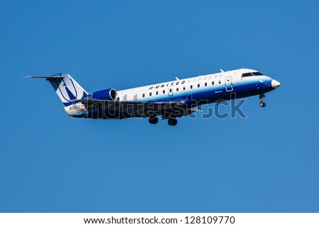 NEW YORK - JANUARY 9: United Airlines Bombardier approaching JFK Airport in New York USA on January 9 2012 United Airlines is a major US airline and world\'s largest by number of destinations
