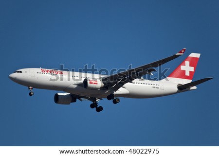 NEW YORK - JANUARY 9: An Airbus A330 Swiss Air lands at JFK Airport on Runaway 31R on January 9, 2010 in New York.