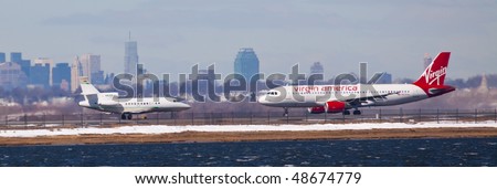 NEW YORK -MARCH 1: Airbus A319 Virgin America airlines Departing from JFK Airport on Runaway 4L with Manhattan skyline in background on March 1, 2010 in New York. Picture taken from Bayswater Park