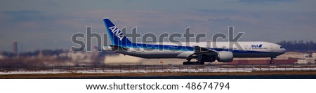 NEW YORK -MARCH 1:Boeing 777 ANA All Nippon Airlines departing from JFK Airport on Runaway 4L with Manhattan skyline in background on March 1, 2010 in New York.