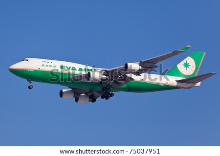 NEW YORK - MARCH 1: Boeing 747 EVA Cargo approaching JFK Airport in New York, USA on March 1, 2011. 747 most popular cargo plane used by commercial airlines Her nickname: Queen of the sky