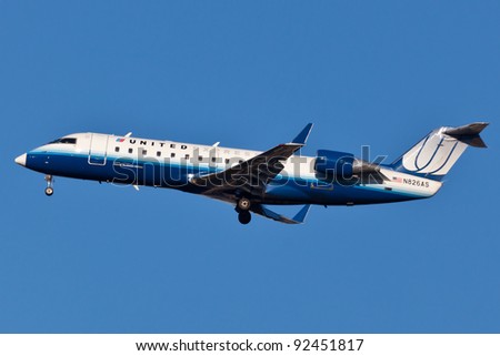 NEW YORK - DECEMBER 21:Embraer 145 United Airline on final to JFK airport located in New York, USA on December 21, 2011 United is world\'s largest airline with over 86000 employees and second by fleet