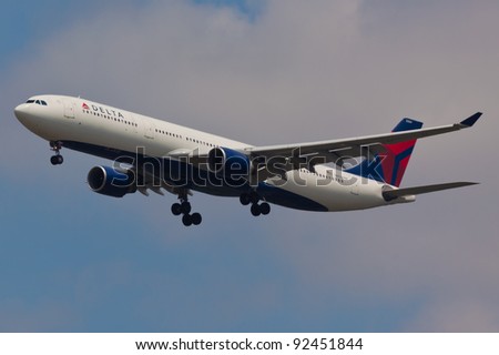 NEW YORK - DECEMBER 21: Airbus A330 approaches JFK Airport located in New York, USA on December 21, 2011 Delta Air Lines is one of the major American Airlines is rated top 10 the biggest in the world