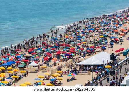 OCEAN CITY - JUNE 10: Beach full of people in Ocean City, MD on June 10, 2012 during OC Airshow. Ocean City, MD is a popular beach resorts on East Coast and one of the cleanest in the country.