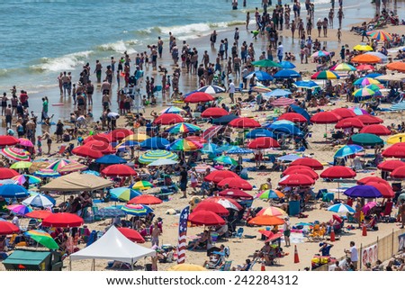 OCEAN CITY - JUNE 10: Beach full of people in Ocean City, MD on June 10, 2012 during OC Airshow. Ocean City, MD is a popular beach resorts on East Coast and one of the cleanest in the country.