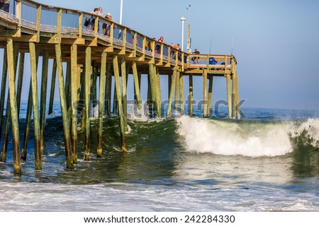 OCEAN CITY - AUGUST 5: Fishing Pier in Ocean City, MD on August 5, 2014. Ocean City, MD is a popular beach resorts on East Coast and one of the cleanest in the country.