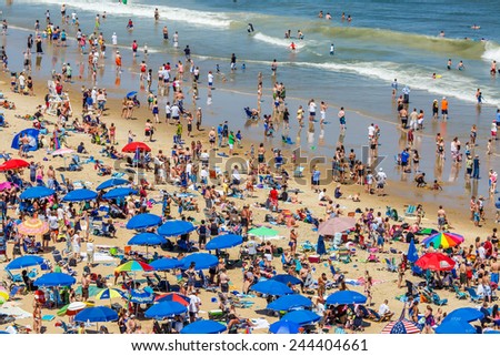 OCEAN CITY - JUNE 14: Beach full of people in Ocean City, MD on June 14, 2014 during OC Airshow. Ocean City, MD is a popular beach resorts on East Coast and one of the cleanest in the country.